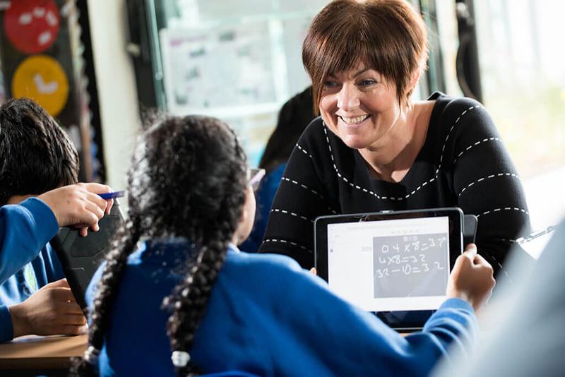 photo of teacher with pupil using lbq on a tablet computer