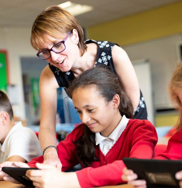 photo of teacher with 2 students in a class